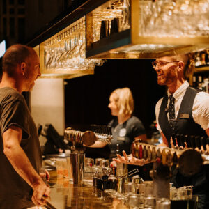 Bar manager serving customer.